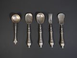 six spoons, forks and spoons are lined up on a black surface