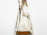 an antique statue of the virgin of guadalupe on a stand