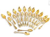 a lot of gold spoons and spoon spoons on a white background