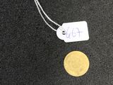 a gold coin with a price tag attached to it