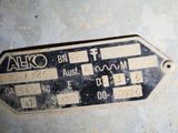 a close up of a metal sign on the floor