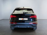 the rear end of a black audi vehicle in a white room