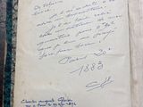 an old book with writing on it sitting on top of a table