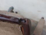 a wooden bench with a metal handle on it