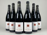 six bottles of red wine lined up in a row