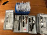 many different watches in the case on the table