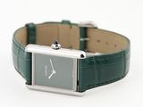 a watch that is sitting on top of a green strap