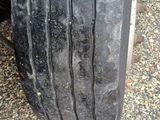 the tire of a truck with a flat tire on the ground