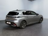 the rear of a silver car in a white room