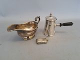 a silver tea pot and a silver teapot on a table