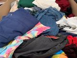 a cardboard box filled with clothes and a price tag