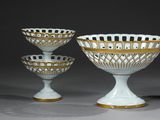 three white and gold glass bowls with gold rims on them
