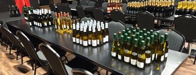 many bottles of wine sitting on a table in a room