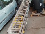 an image of a car parked in a garage with a ladder attached to the back of it