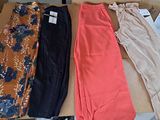 three pairs of pants sitting on a box on a table