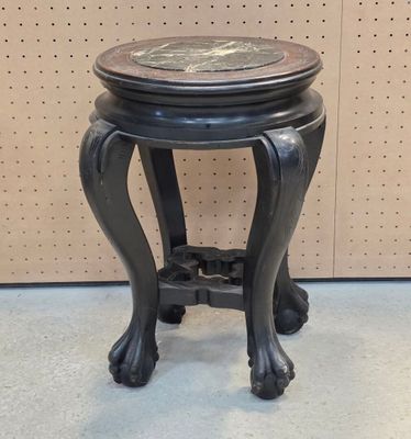 a small black table with a marble top on it