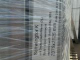 a pallet full of plastic wrap on the side of a building