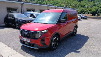 a red van that is parked in a parking lot