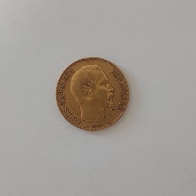 gros plan d'une pièce d'or sur une surface blanche