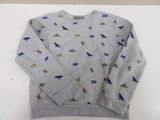 grey sweatshirt with dinosaurs on it on a white surface