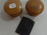 two wooden knobs and a book sitting on a table