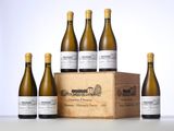 six bottles of white wine in a wooden box on a table