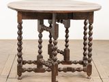 an old wooden table with a wooden top on a wooden floor
