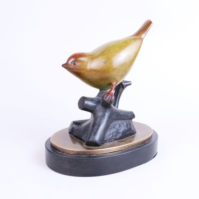 sculpture of a bird perched on a tree branch on a white background