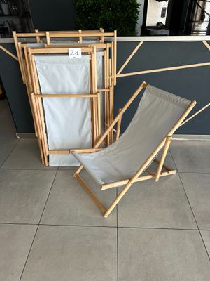 a chair that is next to a rack with clothes on it