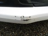 a close up of a car ' s bumper with rust on it