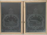 two etched glass windows with a picture of a boat in the water