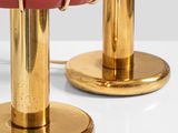 pair of red and gold table lamps in the style of person