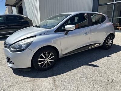 a silver car is parked in front of a building