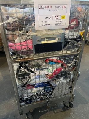 a metal cart with a lot of clothes in it