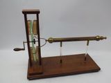 a wooden stand with a clock and a glass tube on it