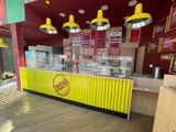 a yellow and red counter in the middle of a restaurant