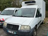 two white vans parked next to each other in a parking lot