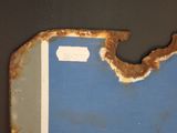 a picture of a piece of metal with rust on it