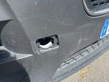 the front bumper of a car with a hole in the bumper