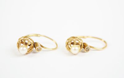 a pair of gold rings with pearls and diamonds