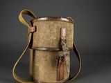 un vieux sac en toile muni d'une sangle et d'une poignée en cuir