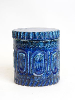 a close up of a blue container on a white surface