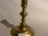 a brass candle holder with a price tag on it