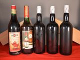 several bottles of wine are lined up on a red cloth