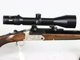 a rifle with a scope on it and a bag on the ground