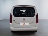 the back end of a white van parked in a white room
