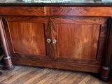a wooden cabinet with a marble top and a sink