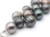 a close up of a strand of pearls on a white surface