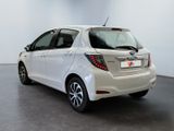 the back of a white toyota yaris parked in a showroom