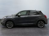 the grey fiat suv is parked in a large room